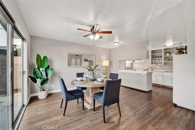 dining space featuring ceiling fan and dark hardwood / wood-style flooring