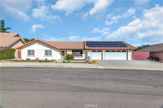 view of front of house featuring solar panels and a garage