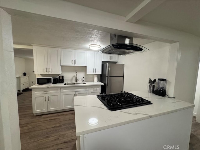 kitchen with light stone countertops, island range hood, sink, black appliances, and white cabinets