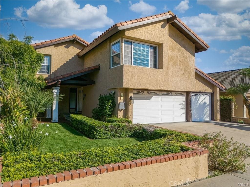 view of front of home featuring a garage and a front lawn