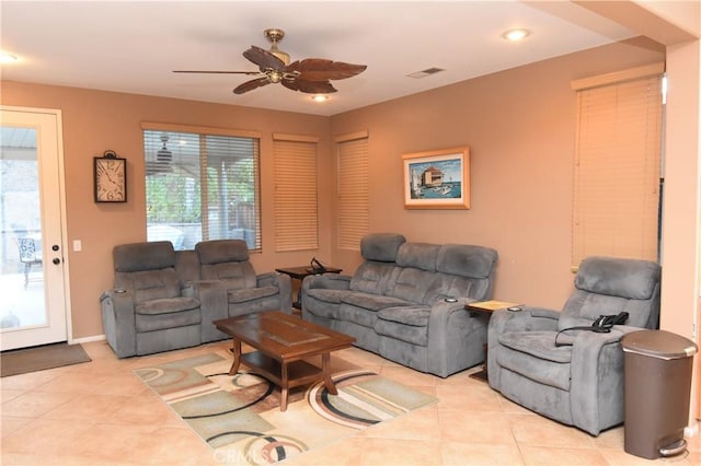 tiled living room with ceiling fan and plenty of natural light