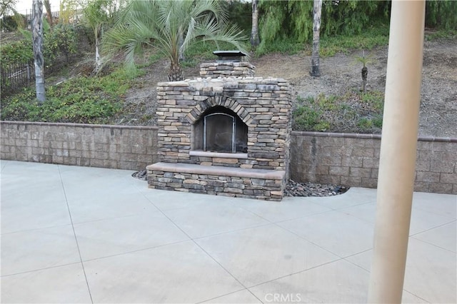 view of patio / terrace featuring an outdoor stone fireplace