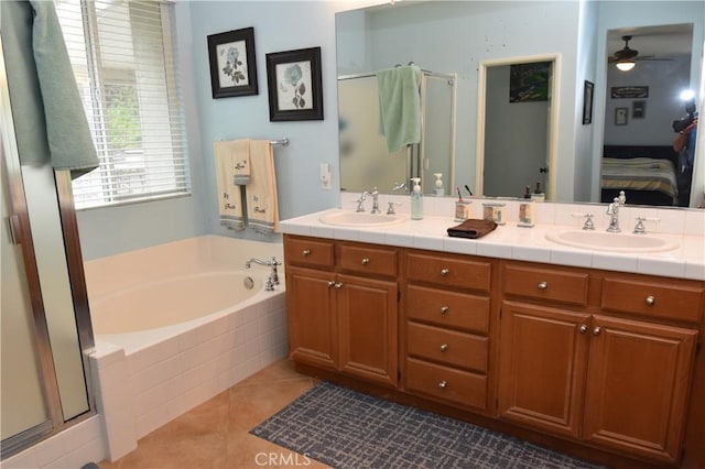 bathroom featuring tile patterned flooring, vanity, ceiling fan, and plus walk in shower