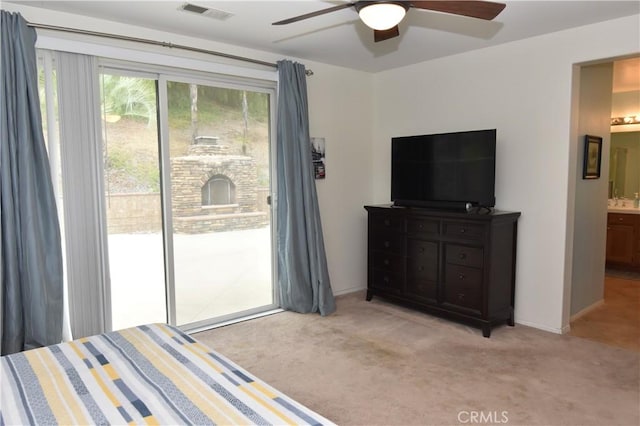 bedroom with connected bathroom, access to exterior, ceiling fan, and light carpet