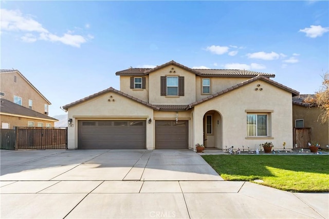 mediterranean / spanish house featuring a garage and a front yard