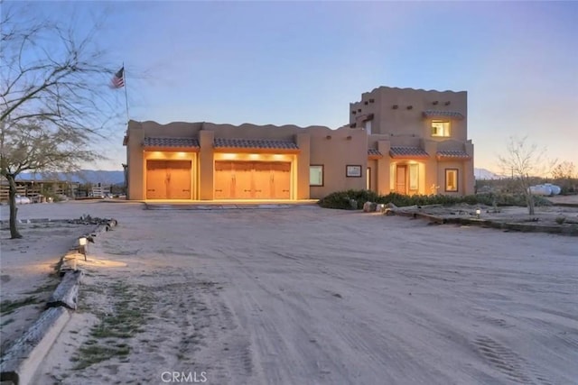 southwest-style home featuring a garage