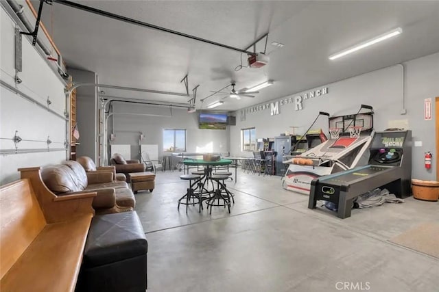 garage featuring a garage door opener and ceiling fan