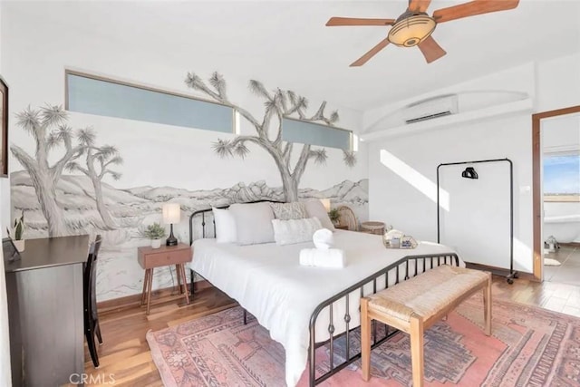 bedroom with light wood-type flooring, a wall mounted AC, and ceiling fan