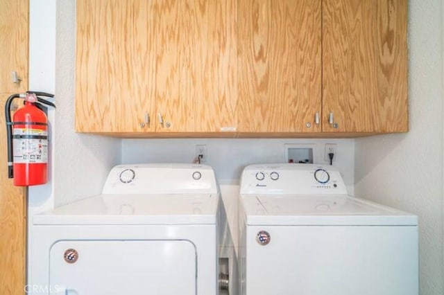 laundry area featuring cabinets and separate washer and dryer