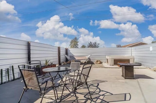 view of patio with an outdoor fire pit