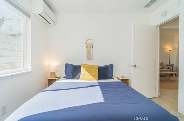 carpeted bedroom with a wall unit AC