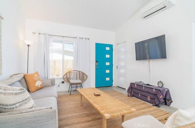 living room featuring a wall mounted AC and wood-type flooring