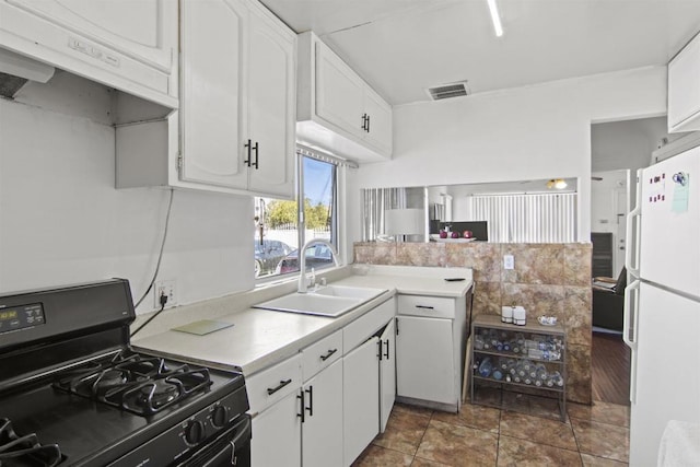 kitchen with white cabinets, sink, white fridge, and black range with gas cooktop