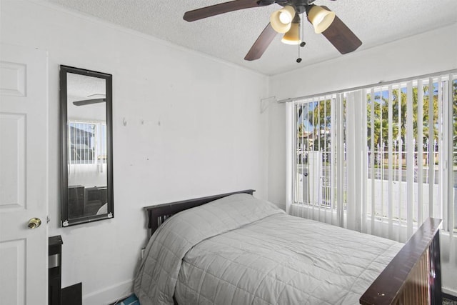 bedroom with a textured ceiling and ceiling fan