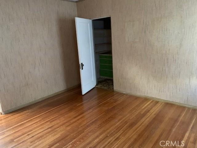 unfurnished room featuring hardwood / wood-style flooring