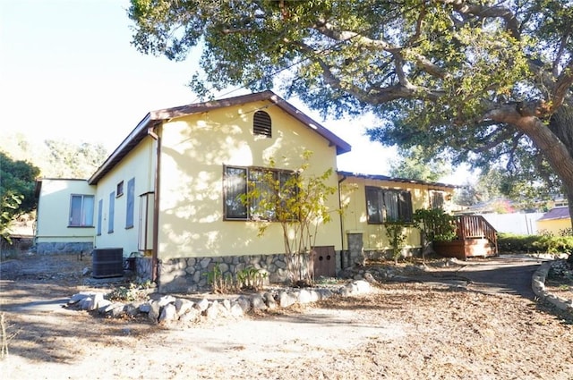 view of front facade with a deck and central AC