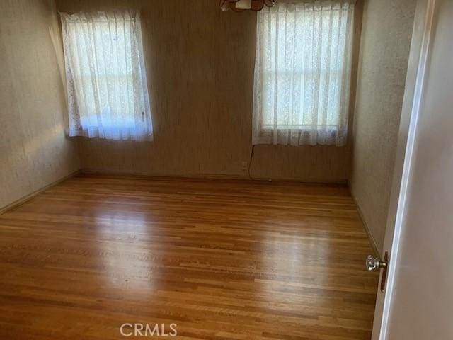 spare room with wood-type flooring