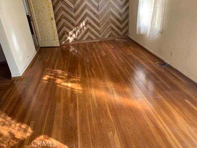 spare room with wood-type flooring