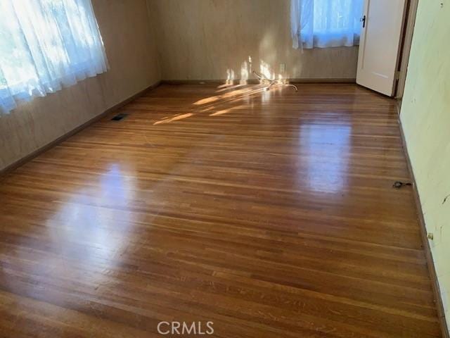 spare room with dark wood-type flooring