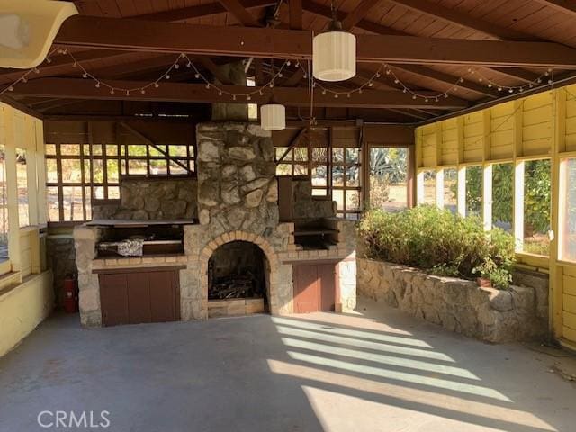 exterior space with a gazebo and an outdoor stone fireplace