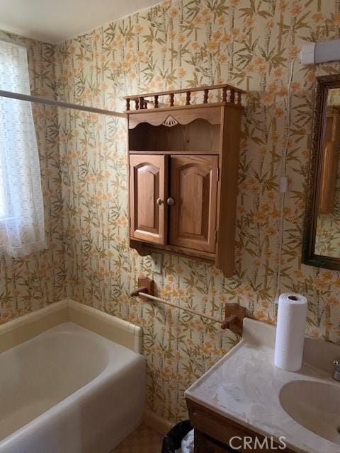 bathroom featuring vanity and a tub to relax in