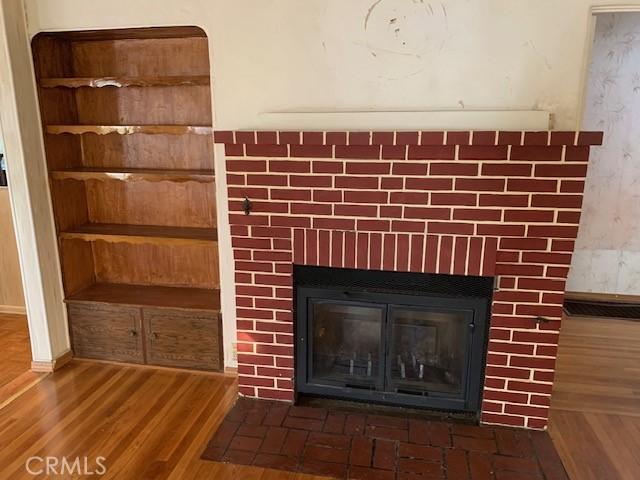 room details featuring hardwood / wood-style floors and a brick fireplace