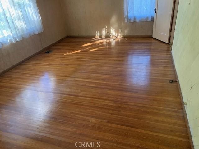 unfurnished room featuring dark hardwood / wood-style floors