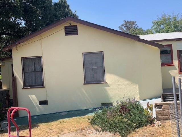 view of home's exterior featuring crawl space and stucco siding
