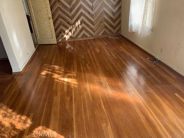 interior space with baseboards and dark wood finished floors