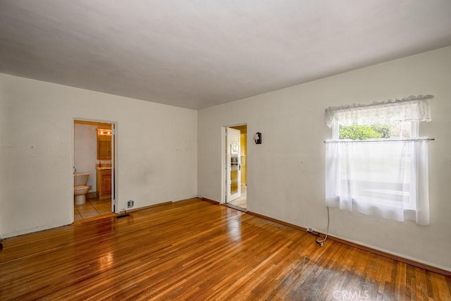 empty room with wood finished floors