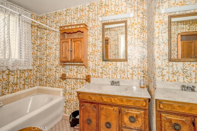 full bathroom with a bath, vanity, and wallpapered walls
