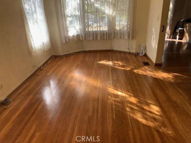 interior space with visible vents and wood finished floors