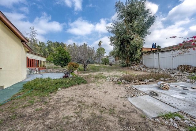 view of yard featuring a patio and fence