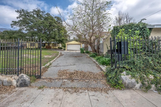 exterior space featuring a front yard, fence, a garage, and stucco siding