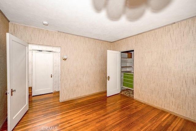 spare room with wood finished floors