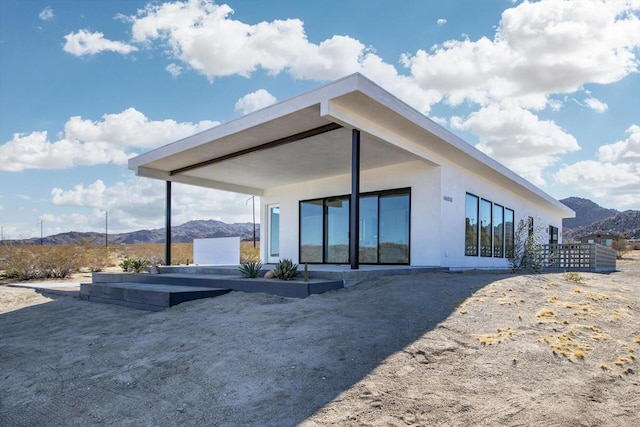 back of house featuring a mountain view