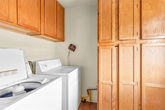 laundry area featuring cabinets and washing machine and dryer