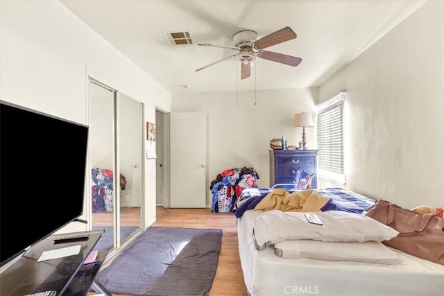 bedroom with ceiling fan and light hardwood / wood-style floors