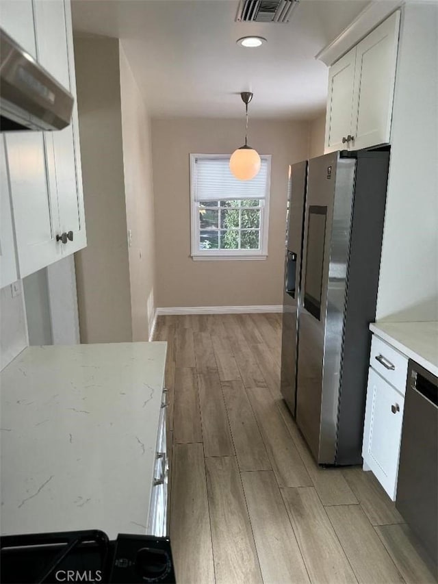 kitchen with white cabinetry, stainless steel appliances, decorative light fixtures, exhaust hood, and light wood-type flooring