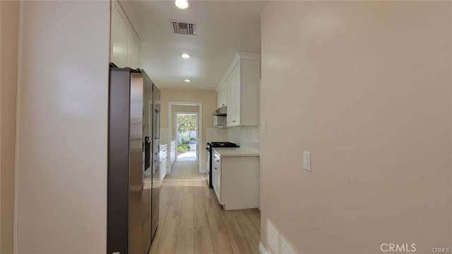 corridor with light hardwood / wood-style flooring