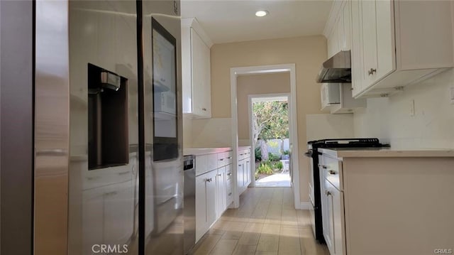 kitchen featuring light wood-type flooring, white range oven, and white cabinetry