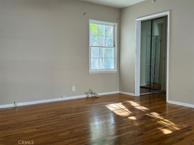 empty room featuring dark wood-type flooring