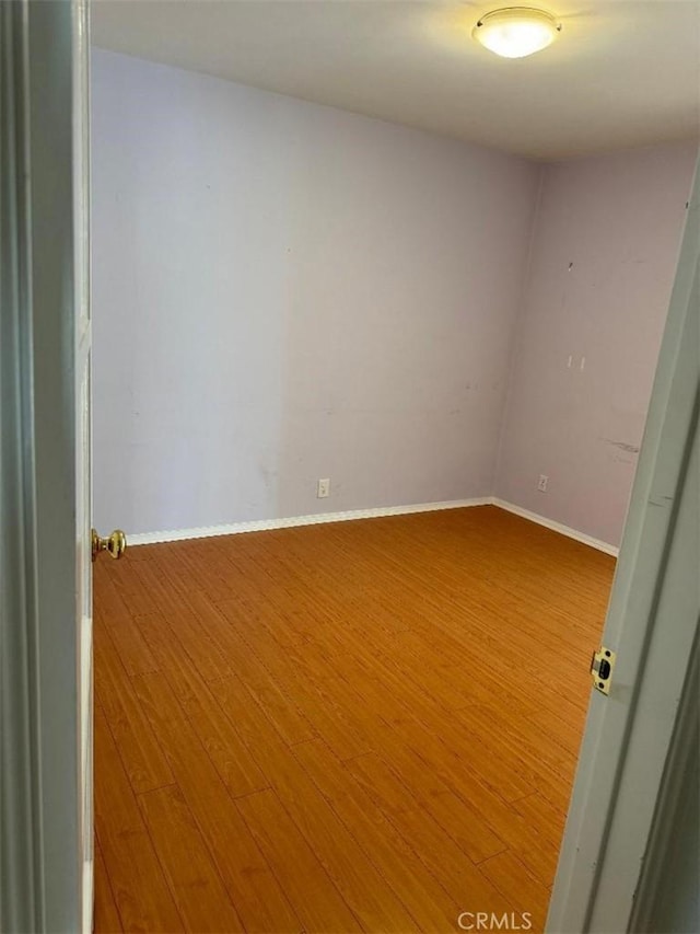 unfurnished room featuring hardwood / wood-style flooring