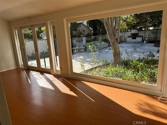 doorway with french doors and hardwood / wood-style flooring