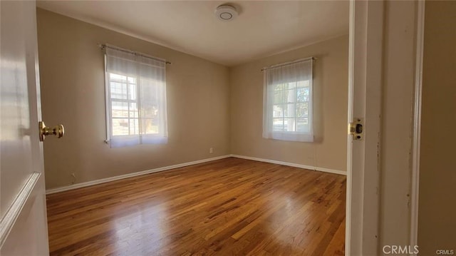 unfurnished room featuring hardwood / wood-style flooring