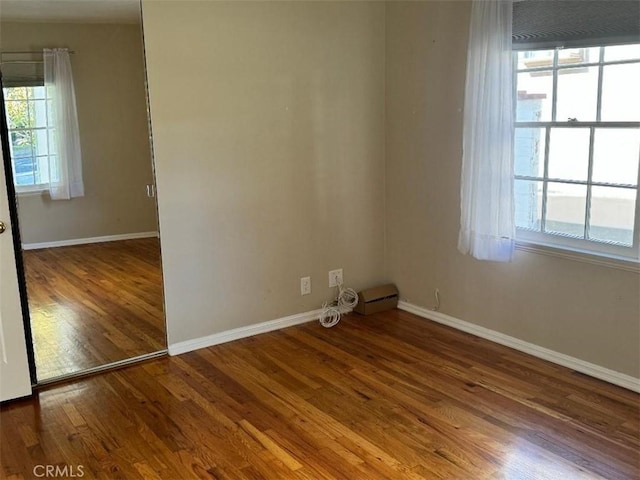 spare room with wood-type flooring