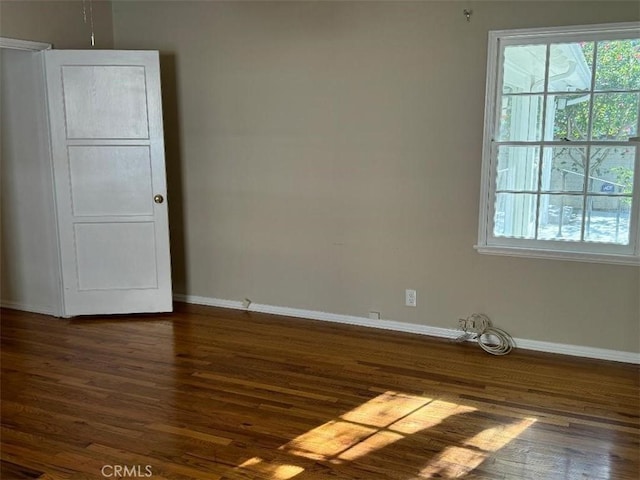 empty room featuring dark wood-type flooring