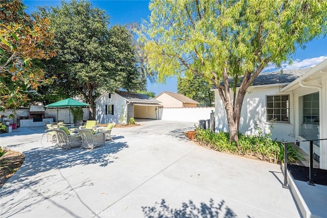 view of front of house featuring an outbuilding and a patio area