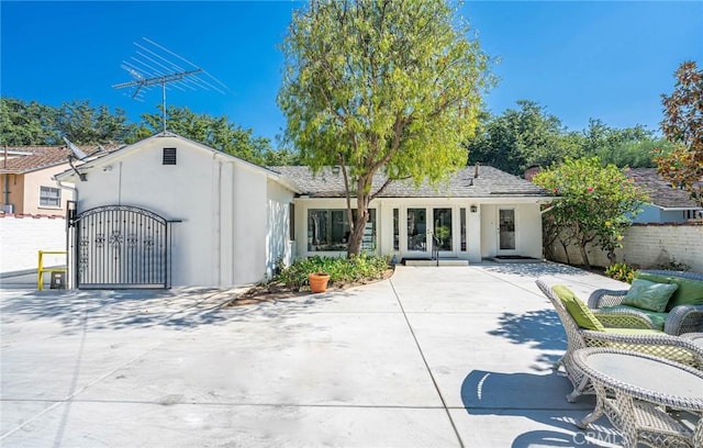 back of property featuring a patio