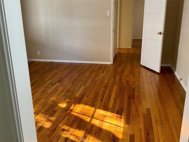 empty room featuring dark wood-type flooring